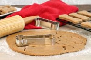 homemade pet treat dough rolled out with a biscuit cookie cutter and rolling pin